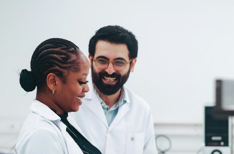 Two clinical scientists working together with test tubes in a laboratory